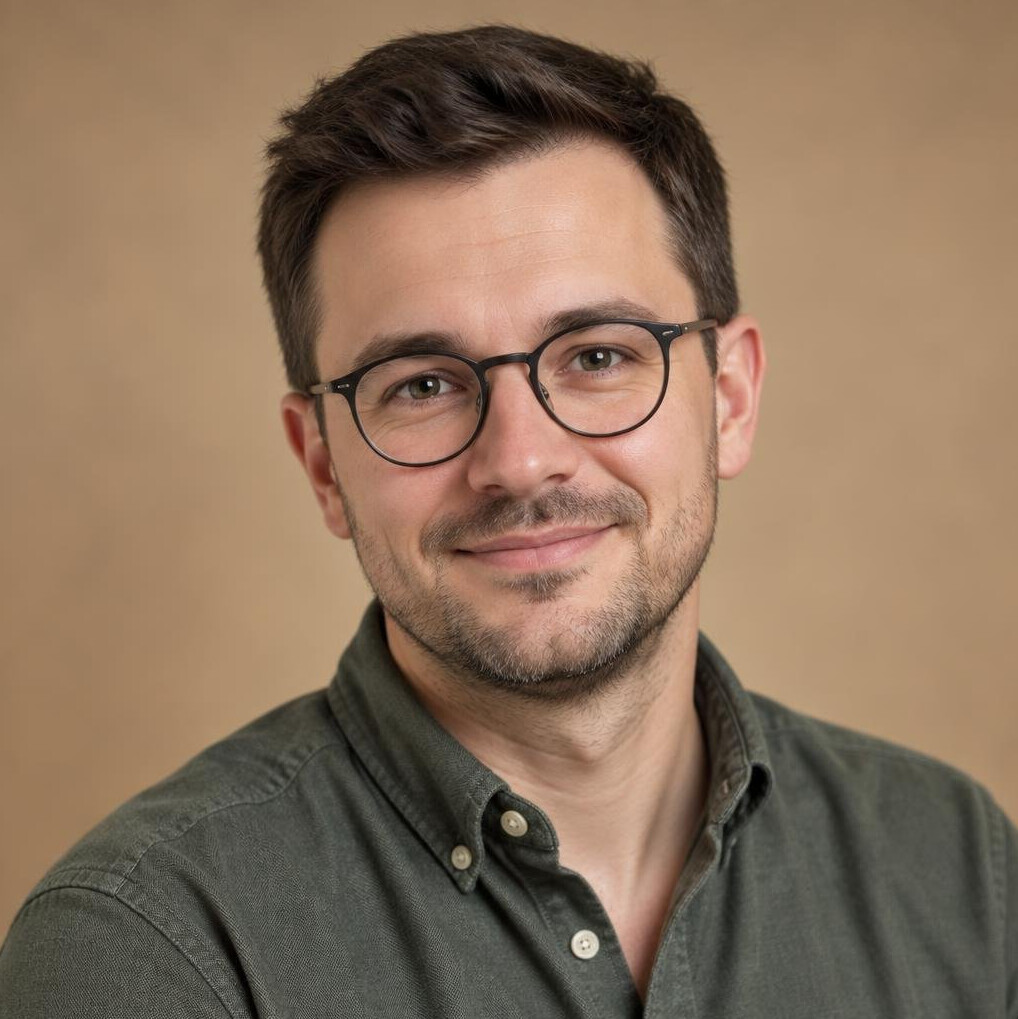 Studio portrait of a Polish man with glasses smiling